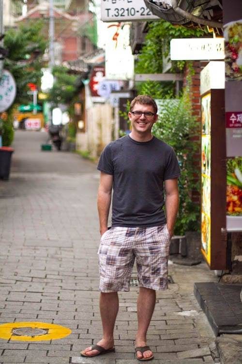 Man standing on a sidewalk.