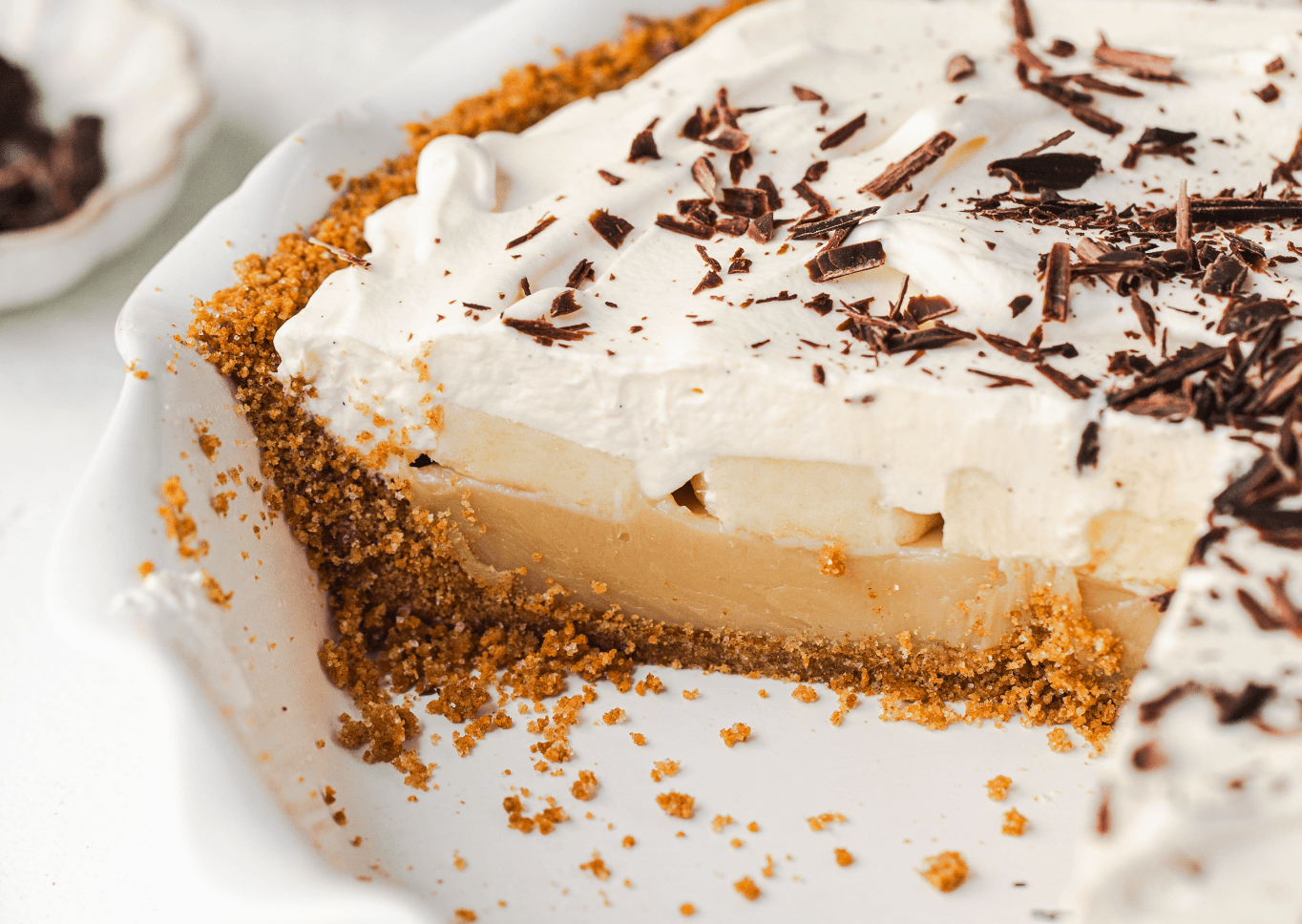 Sliced banoffee pie in pie plate.