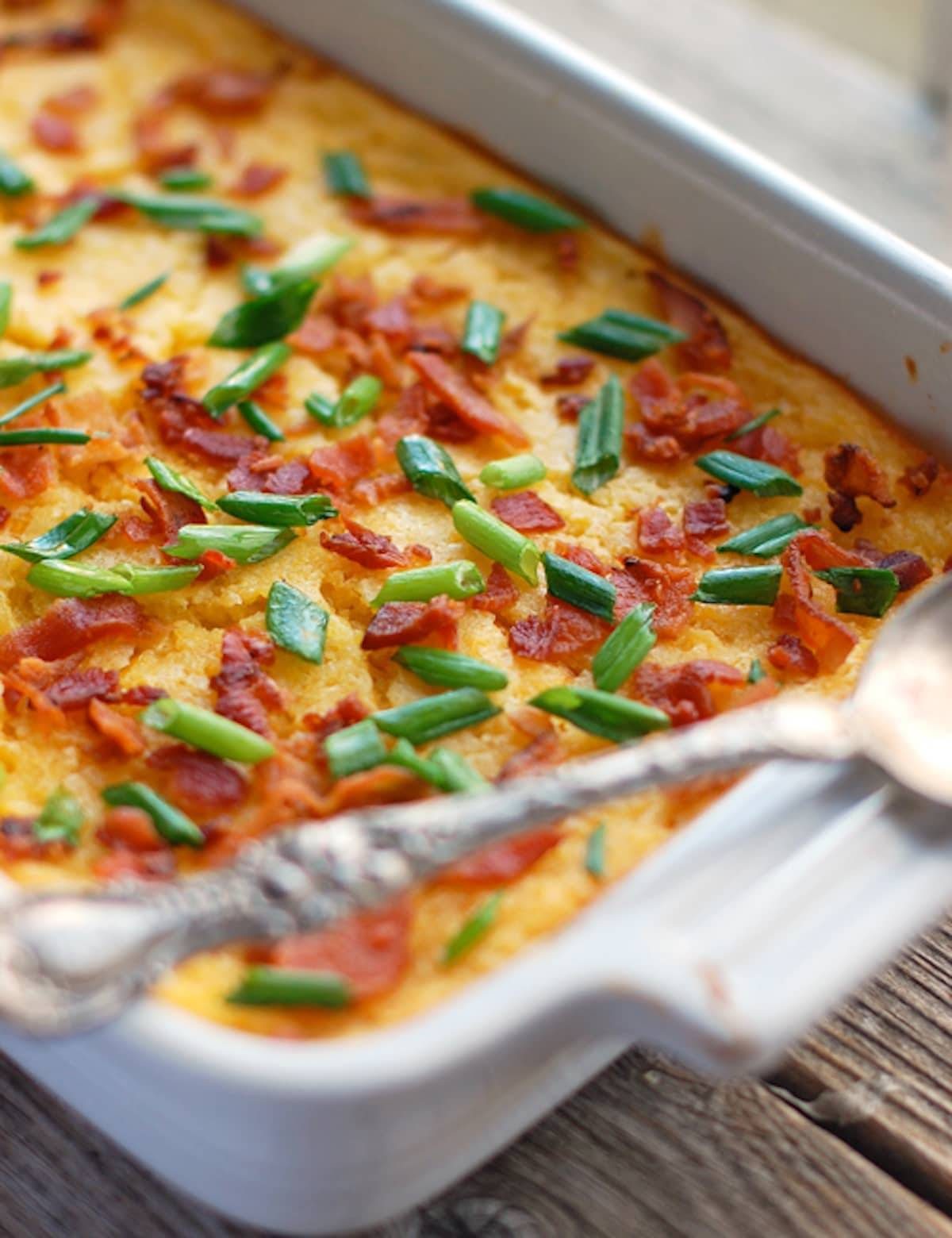 Creamy baked corn in a white baking dish.